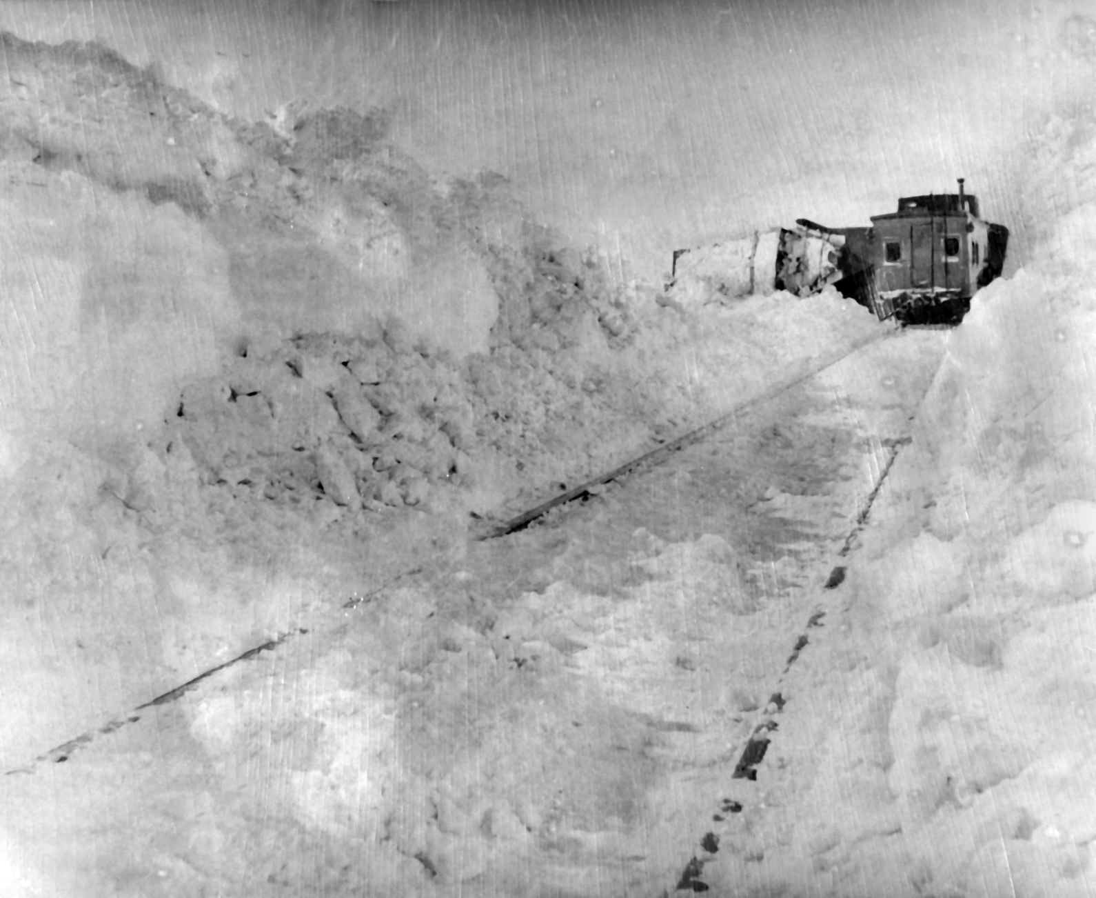 The rear of a work train in a deep drift. The train worked most of the way through the drift, but got stuck and returned to Callaway. Published Jan. 20, 1949.